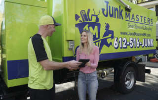 Junk Masters junk removal expert with a satisfied customer