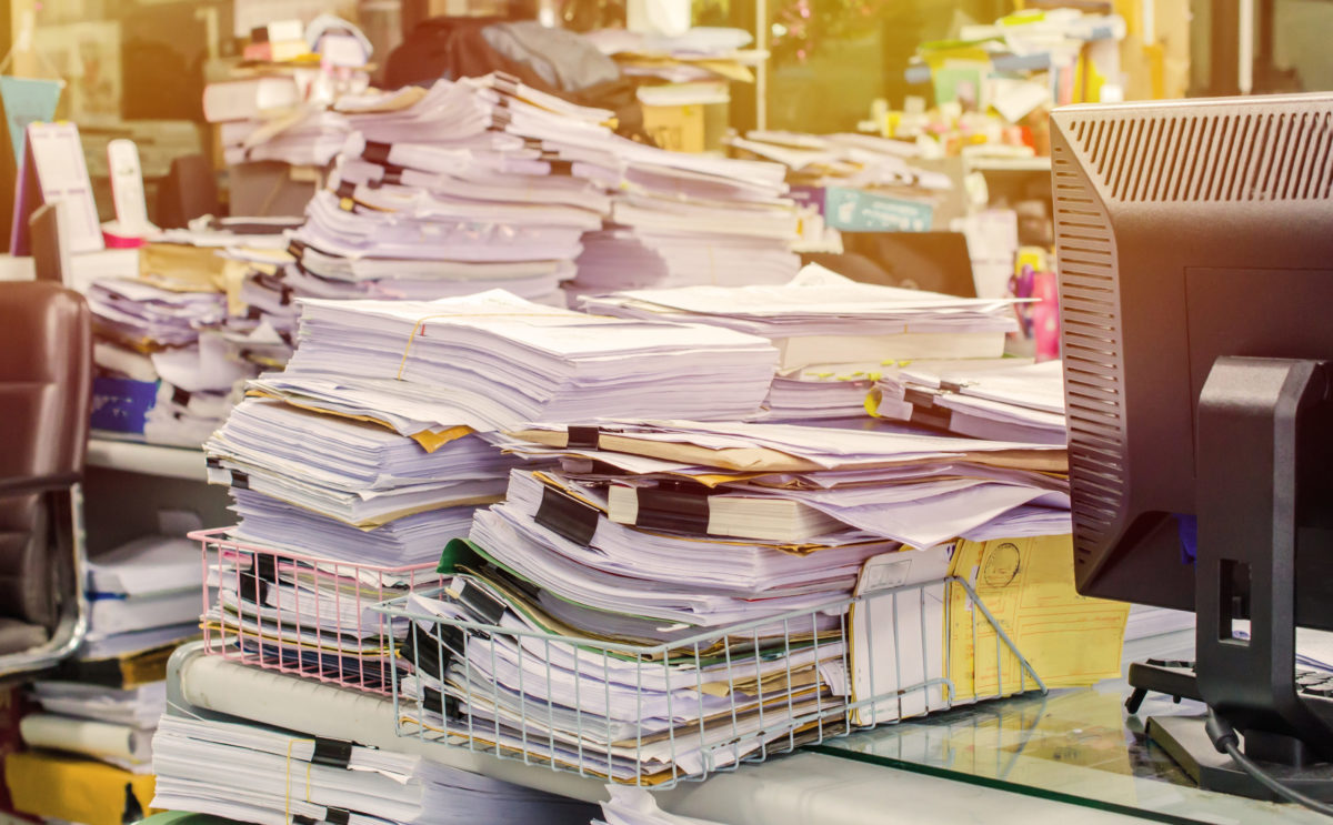 pile of papers piling up in an office