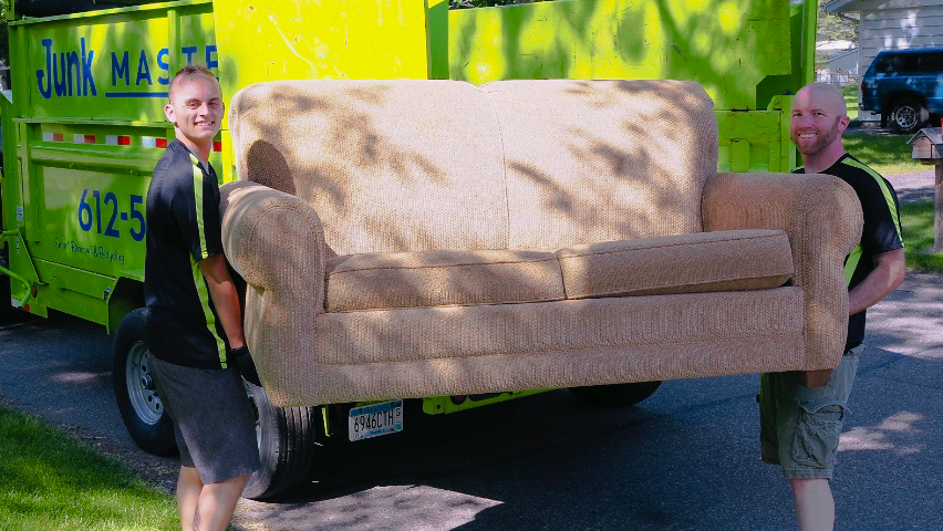 Junk Masters pros hauling a sofa