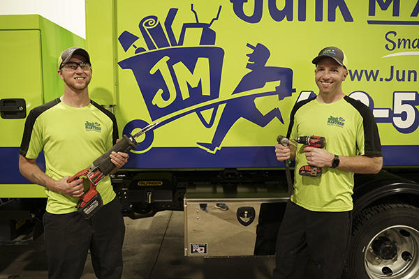Junk Masters pros posing with demolition tools