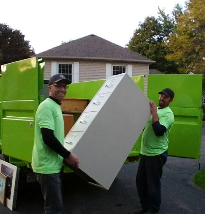 Junk Masters pros hauling a filing cabinet away