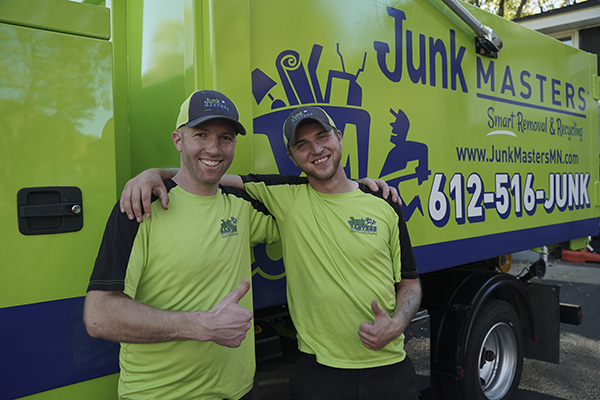 Junk Masters crew smiling next to the truck ready to provide junk removal services in Maplewood