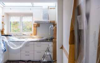 Renovated kitchen with plastic covering the countertops